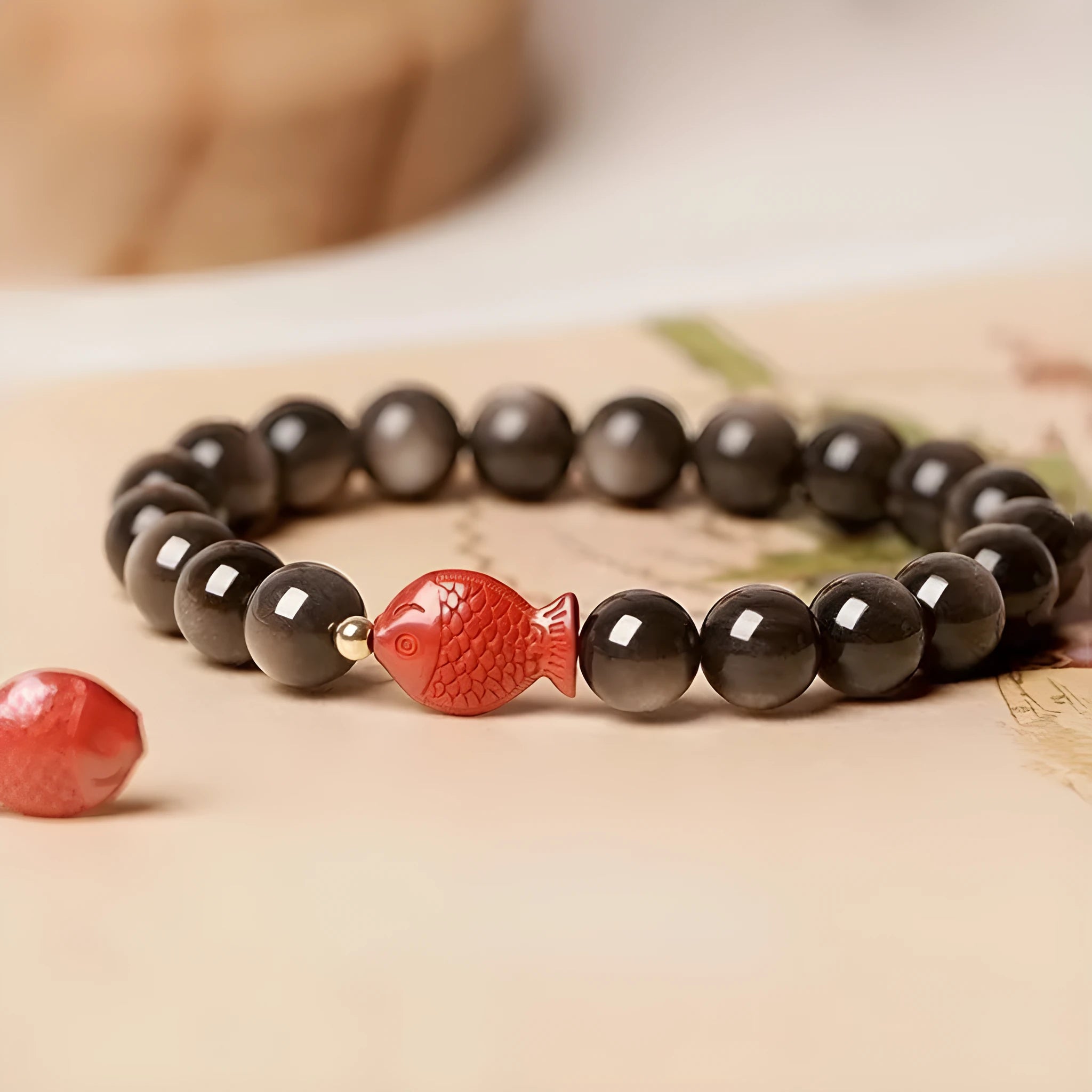 Natural obsidian bracelet with round cinnabar beads in three size options on a wrist