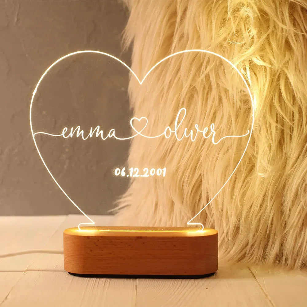 Custom transparent acrylic LED night light with personalised names and date engraving.