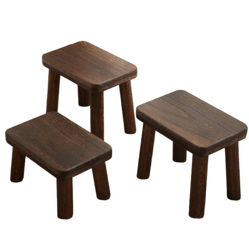 Solid wood distressed finish shoe changing stool with bracket legs.