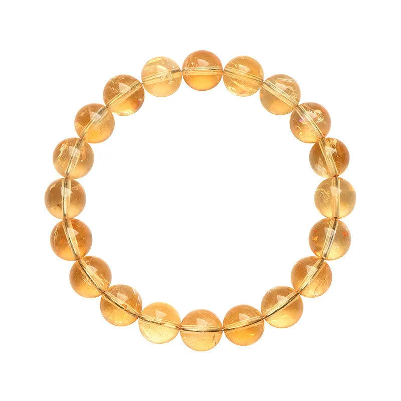 Natural yellow citrine gemstone bead bracelet on a wrist, showing geometric beads.