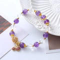 Handmade women's purple crystal bracelet with a micro-inlaid cherry flower charm.