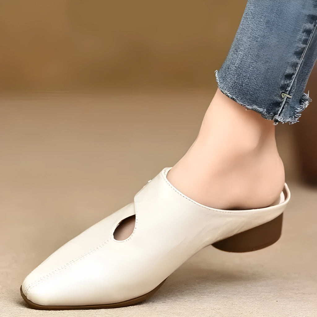 Women's slip-on slippers in first-layer sheepskin with hand-stitched pattern and hollow-out design, beige colour, low heel.