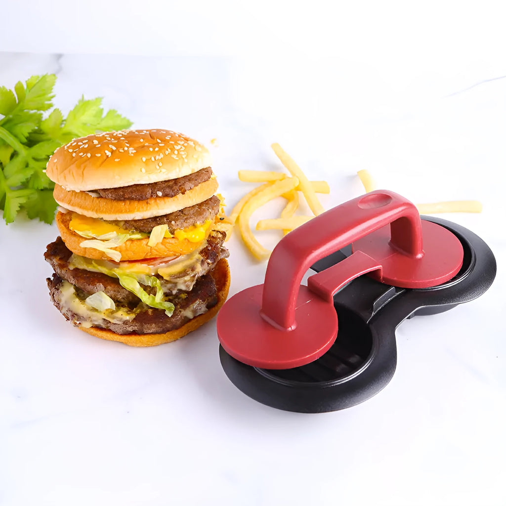 Black food-grade ABS burger press kitchen gadget on a kitchen counter.