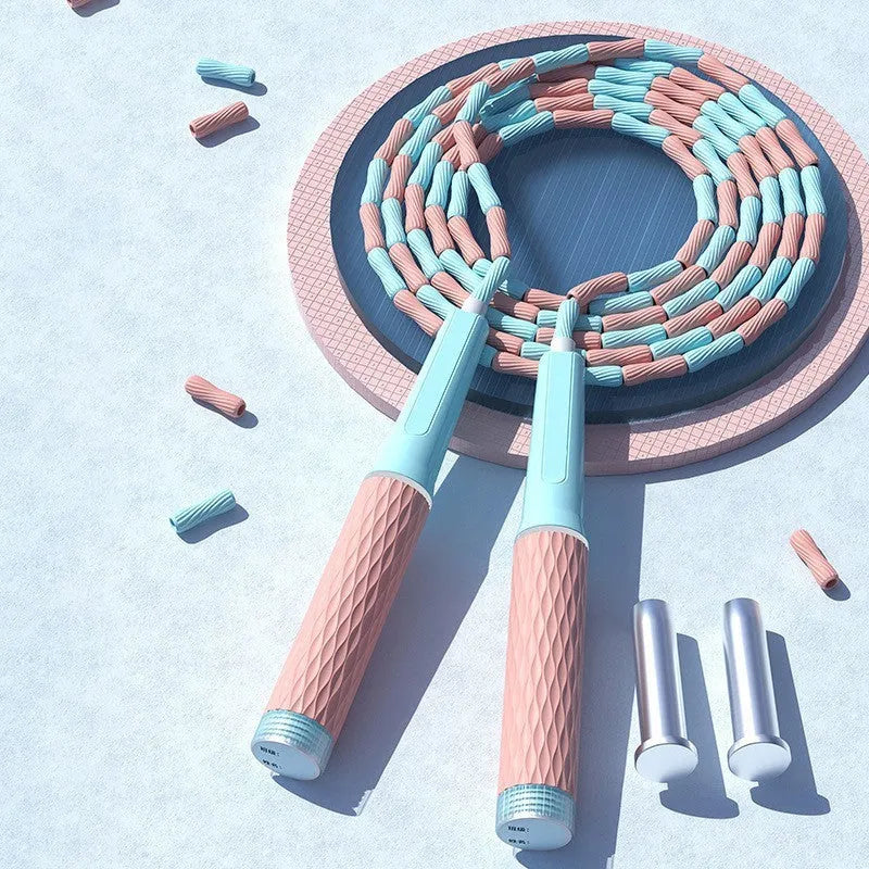 Children's skipping rope with soft blue bead handles and a non-knotted beaded cord.