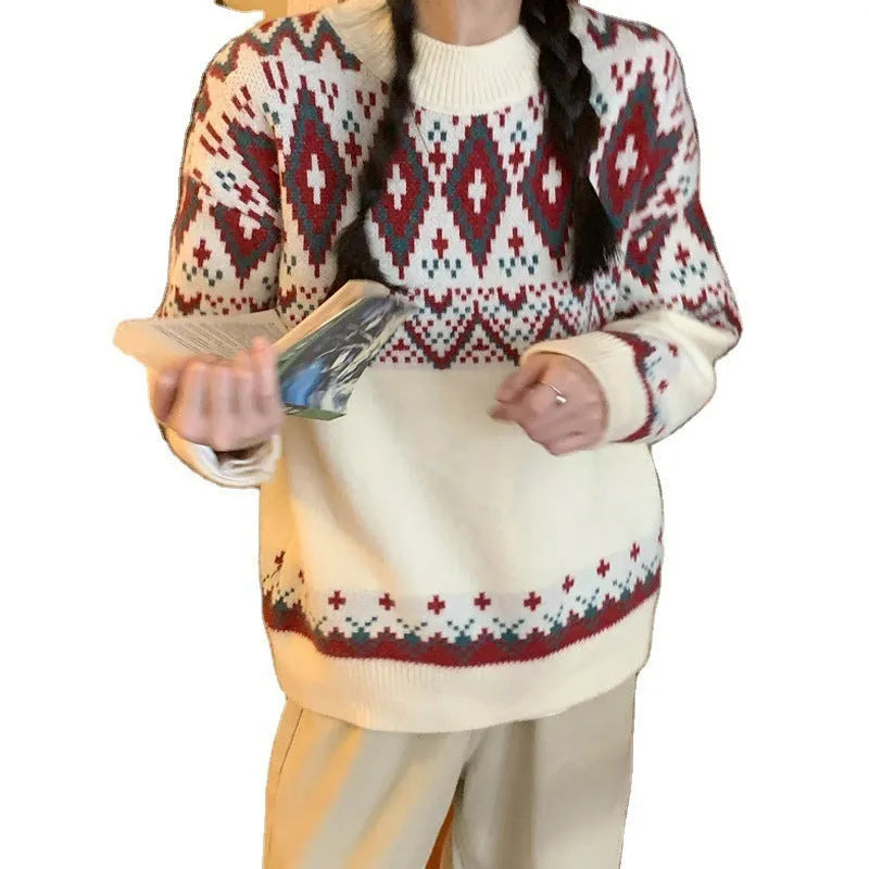 Loose red and white striped retro pullover knitted top with long sleeves on a hanger.