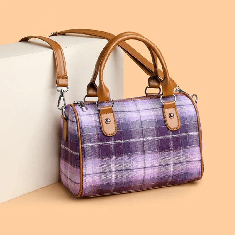 Plaid academy style round barrel canvas shoulder bag with three-dimensional pocket, available in blue plaid.