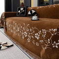 Embroidered magnolia chenille sofa cover in Garland-Black, 180x130cm, with soft texture and floral pattern.