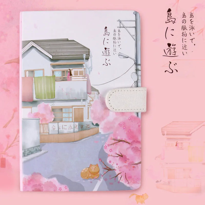 A5 wire-bound retro notebook open showing full-colour vintage illustrations, with a pen.