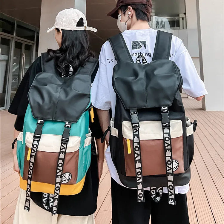 A black Oxford cloth backpack showing its size, carried over one shoulder.
