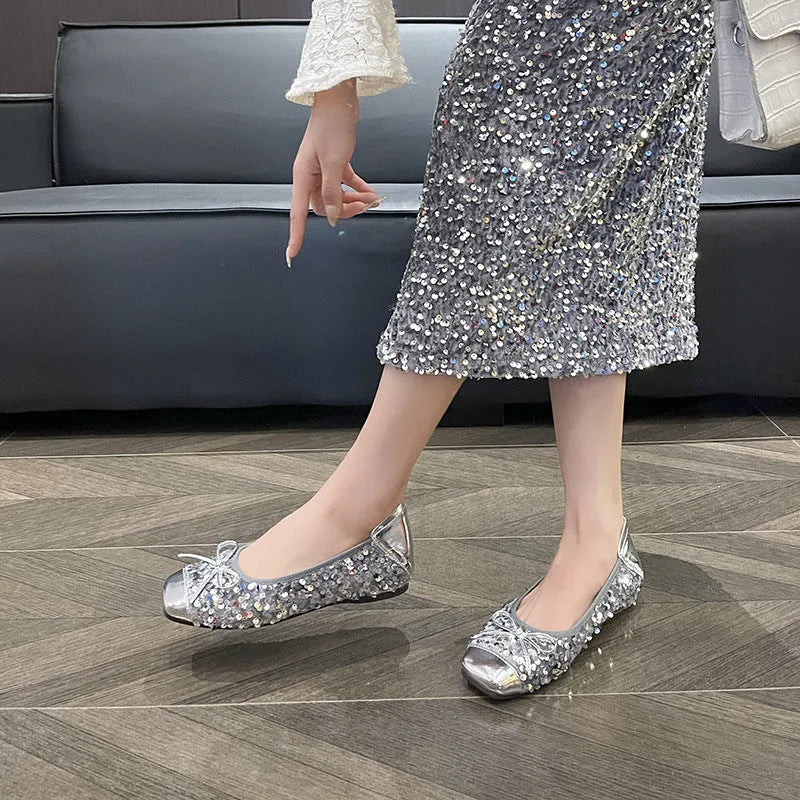 Women's black satin Mary Jane pump with height increasing insole, rhinestones, buckle, and square toe