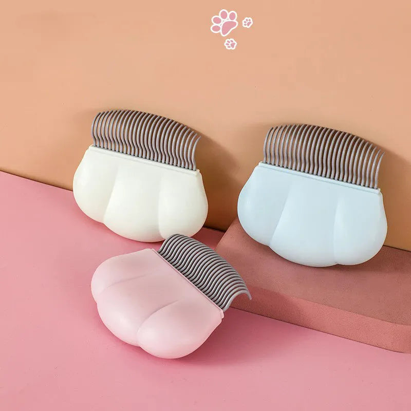 Paw Soft deshedding brush for pets in blue, pink, or white, measuring 9cm by 9cm.