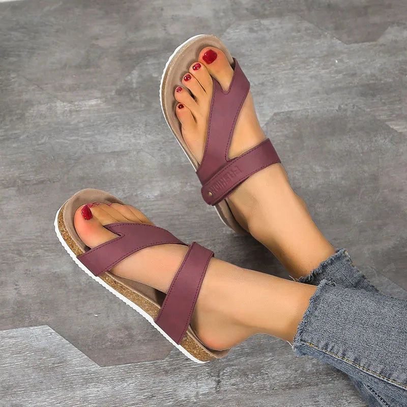 Flat thong sandals with a toe ring and thick foam sole in a solid colour.