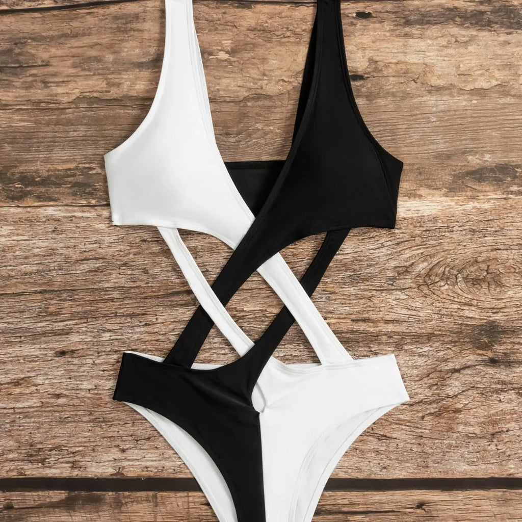 White women's one-piece swimsuit with colour-block panels and hollow-out design details.
