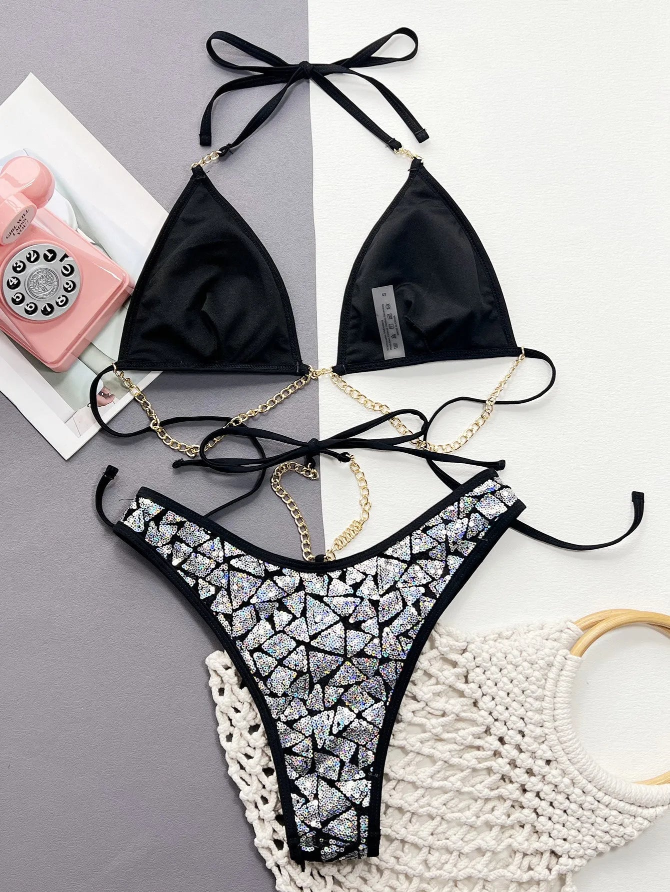 Women's silver black bikini suit with chain design detail on the top and briefs.