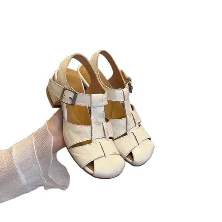 Women's woven Roman shoes with round toe and buckle in apricot and black colours on display