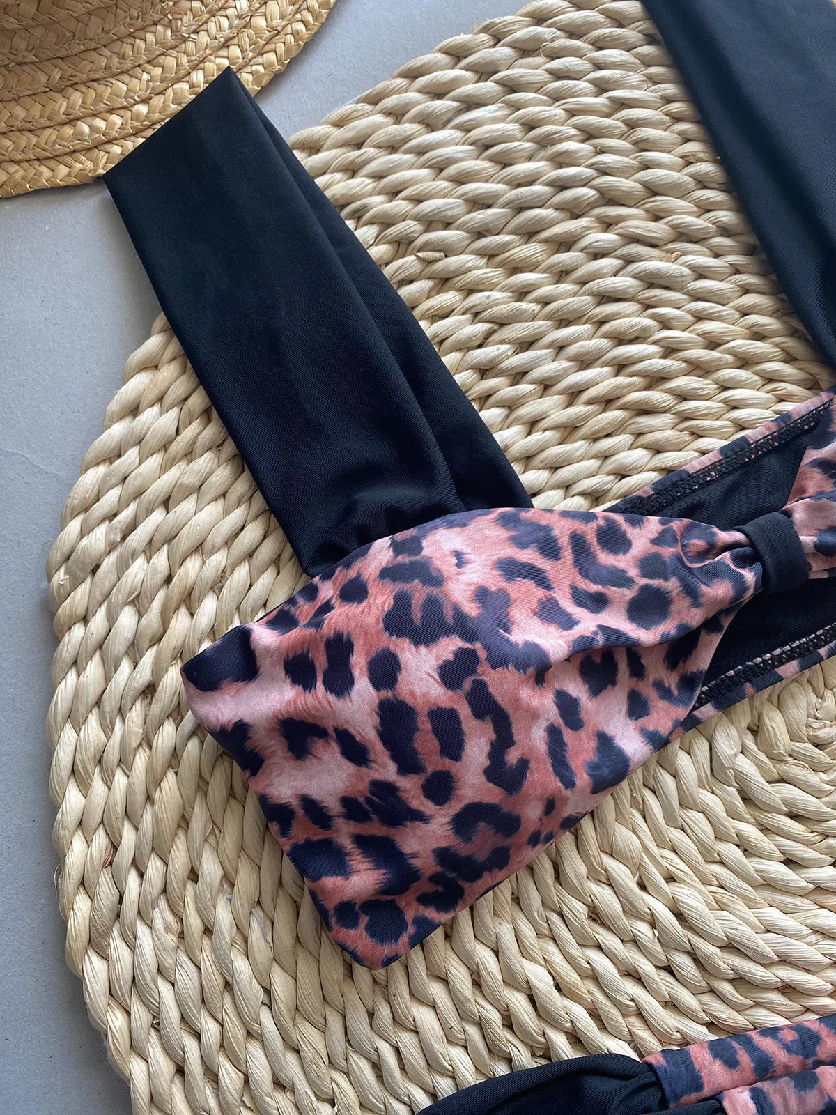 Leopard print women's bikini set showing sleeveless tube top and T-pants on a mannequin.
