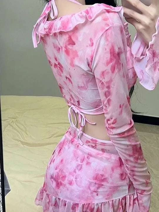 Women's cherry blossom pink floral print bikini swimsuit set laid flat.