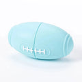 Blue silicone rugby ball dog toy with hollow treat compartment on a wooden floor