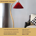 Retro vertical table lamp with a fabric shade in log white, placed on a bedside table.