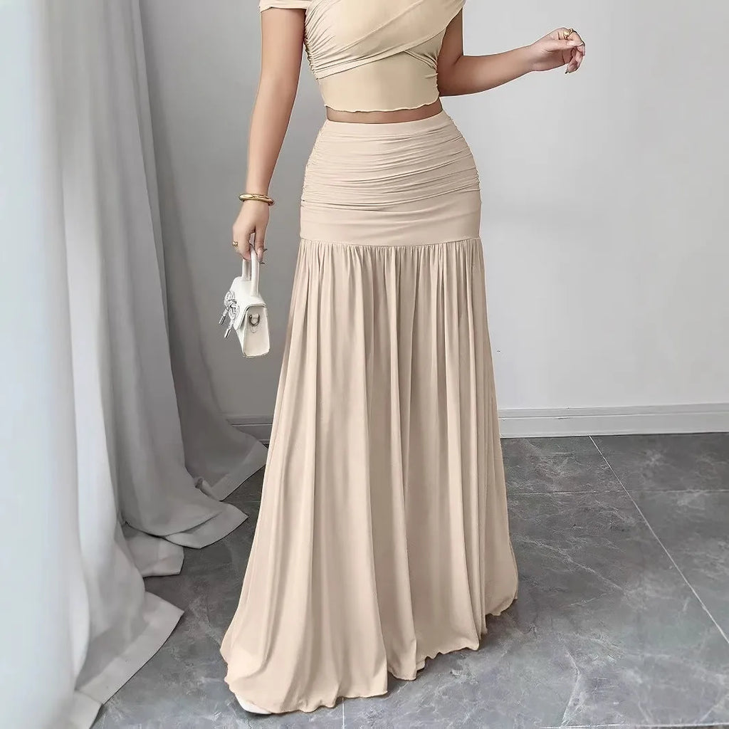 Women's pleated long skirt in polyester with irregular hem available in pink and beige sizes S to XXL