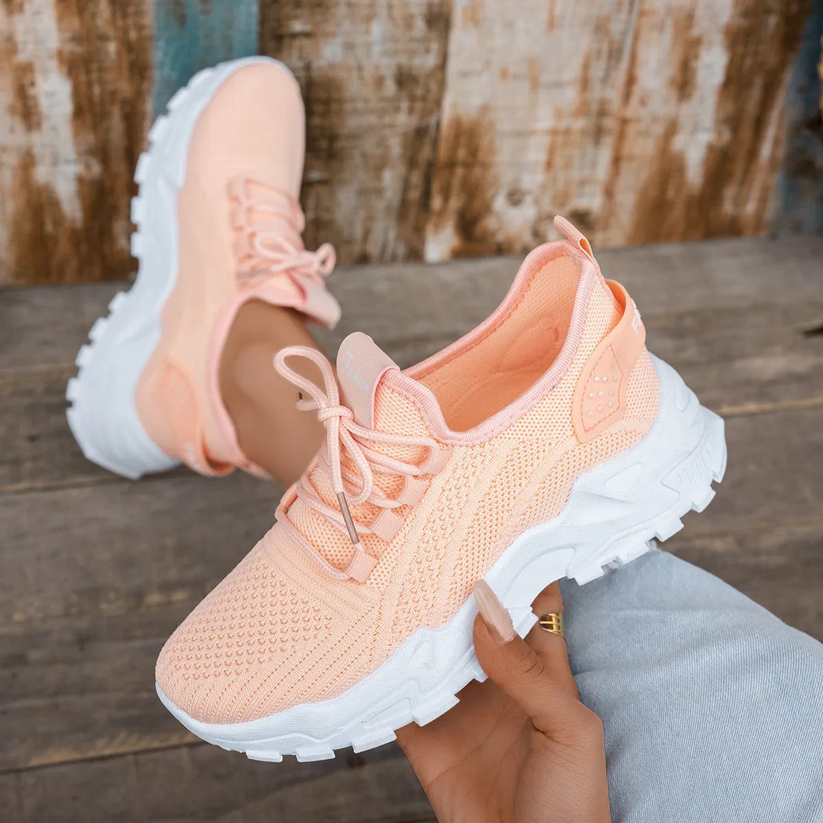 Women's Flyknit mesh casual trainer in multiple colours on a white background, showing lace-up front and round toe design