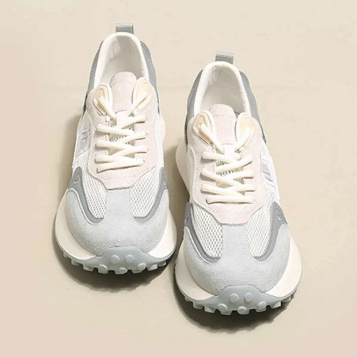 Women's grey and pink retro sneaker with low-top design and round toe