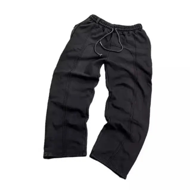 Men's loose cropped polyester sweatpants with quilted tooling style in black, grey, or green