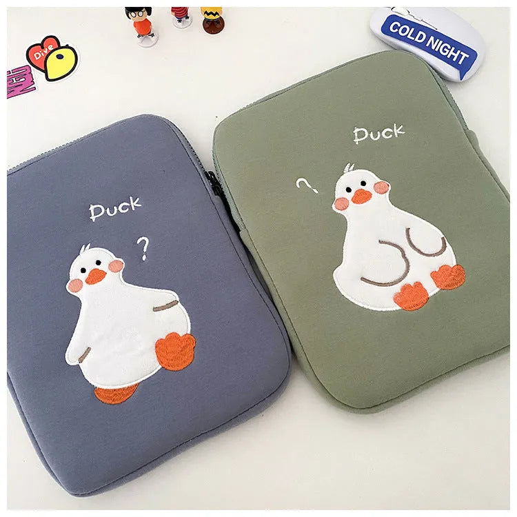 Blue tablet case with embroidered cartoon duck design and a silver zipper closure.