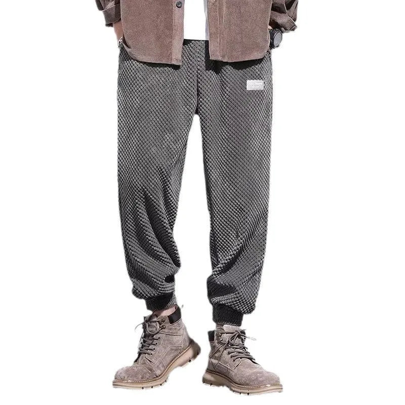 Men's grey straight leg sweatpants with an ankle tie strap, laid flat.