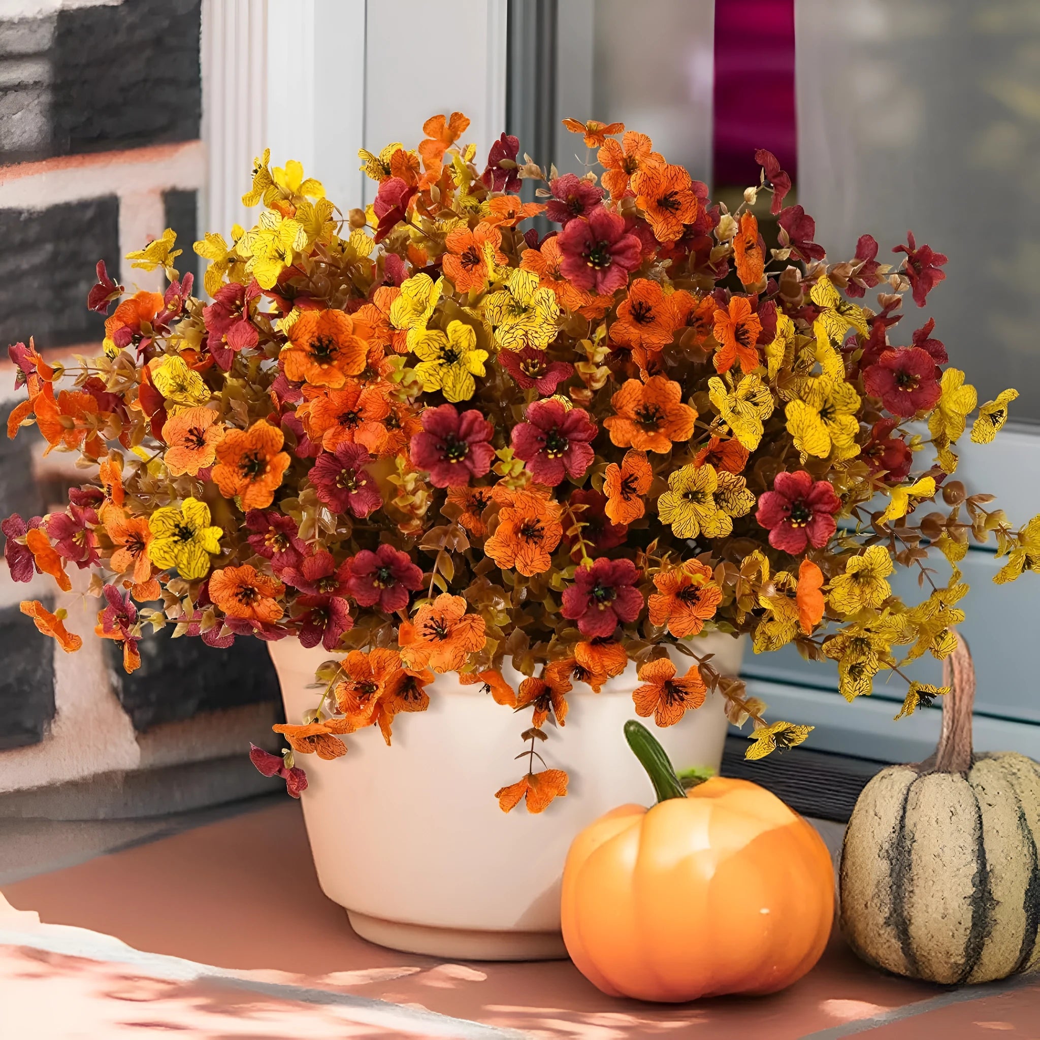 Artificial silk flower bouquet in autumn red, yellow, and orange colours for home or wedding decoration.