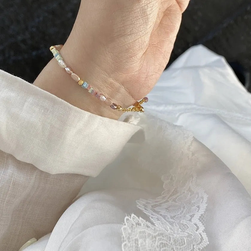 Natural silver pearl bracelet with 14K gilded purple finish and matching necklace on a U-shaped chain.