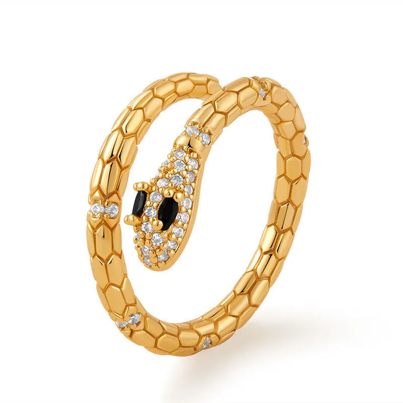 Snake-shaped adjustable copper ring with gold colour finish on a model's index finger.