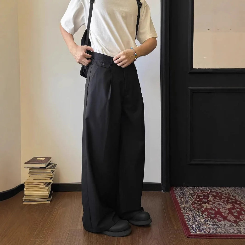 Man wearing brown straight wide-leg casual suit trousers made from a polyester blend fabric.
