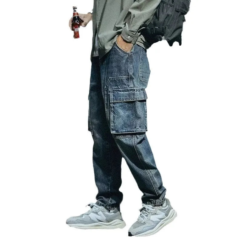 Blue men's loose straight leg retro style trousers with a zip fly on a hanger.