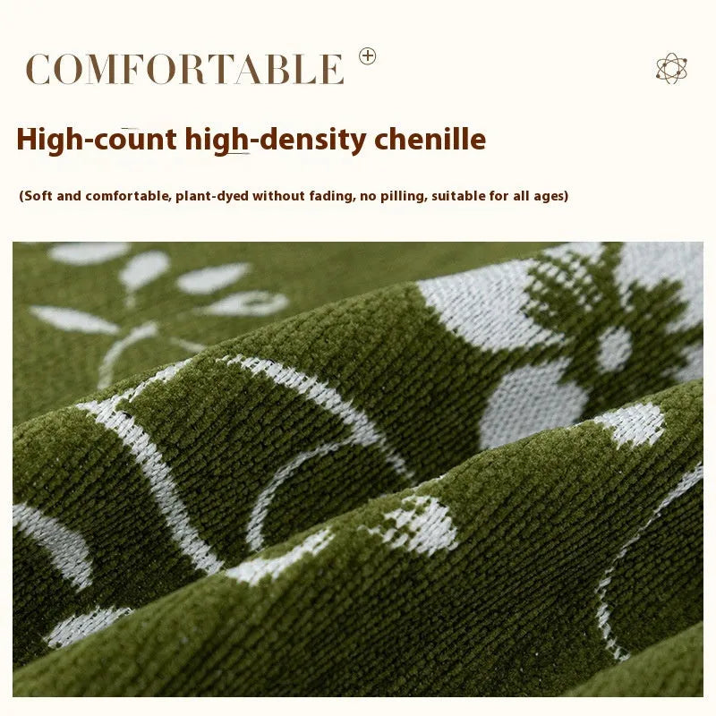 Embroidered magnolia chenille sofa cover in Garland-Black, 180x130cm, with soft texture and floral pattern.