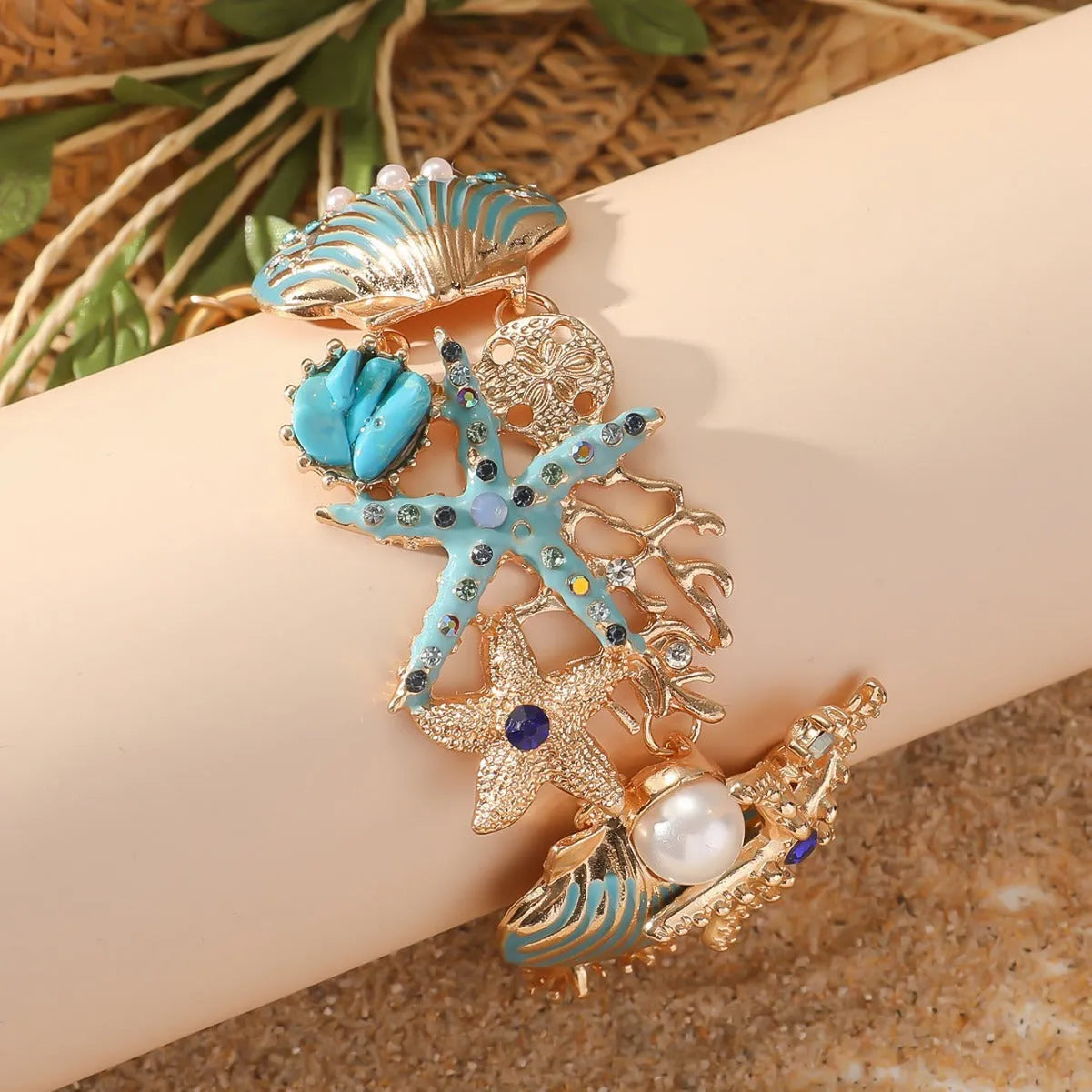 Women's alloy bracelet with starfish, star, and anchor design in turquoise, red, or blue colour.