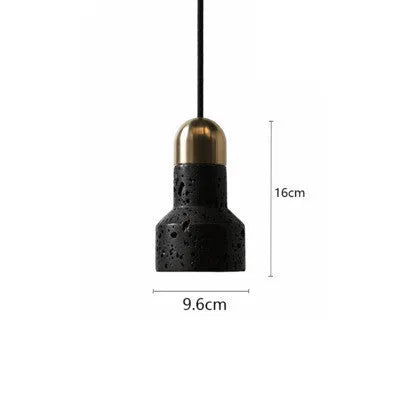 Industrial style black iron chandelier light hanging above a wooden bar table.