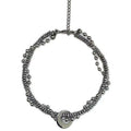 Silvery hand-woven titanium steel hip hop necklace with winding heavy industry chain texture on white background