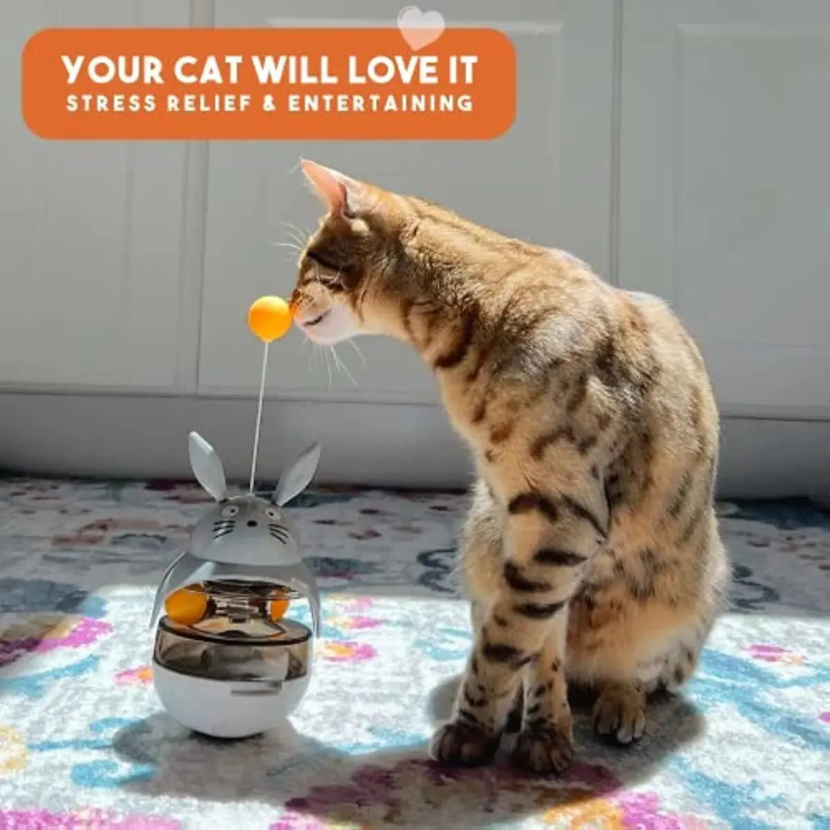 Interactive cat feeder toy with sounding bell and car tower shape in brown, grey, pink, and white