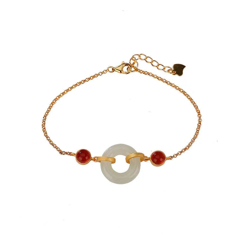 Gold plated S925 sterling silver bracelet with an inlaid natural Hetian jade peace buckle charm.