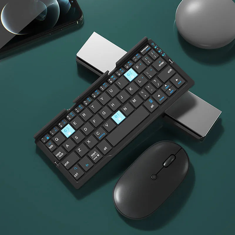 Silver white folding Bluetooth keyboard open with stand holding a smartphone, shown next to its compact folded size.