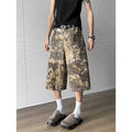 Yellow cotton jeans with a detailed snake pattern and camouflage print, featuring a cropped leg length.