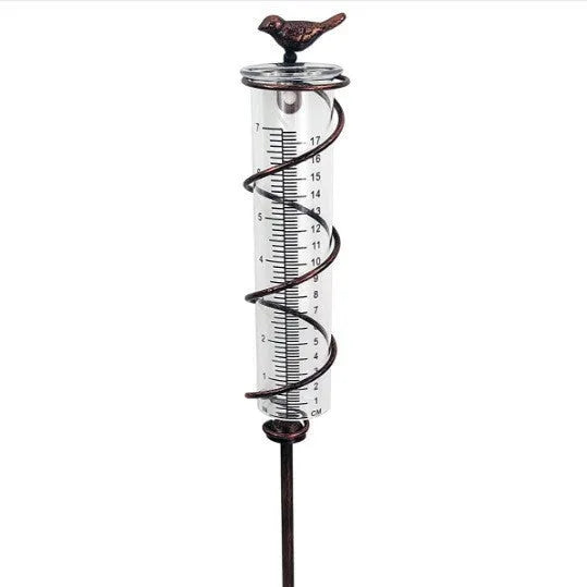 Cast iron hummingbird garden rain gauge with glass measurement tube showing 1-20 scale.
