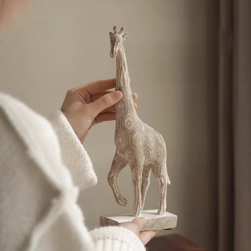 Wood-colour European-style resin giraffe decorative ornament on a shelf.