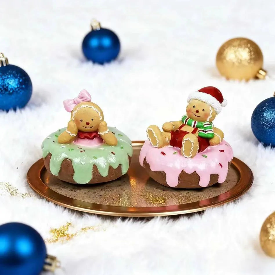 Hand drawn cartoon resin gingerbread man Christmas ornament with pink donut motif on white background