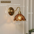 Retro brass glass wall lamp with stone pattern shade in transparent colour, mounted on a wall