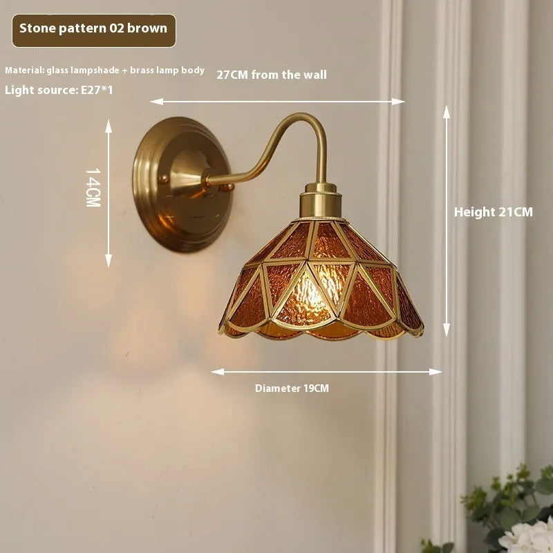 Retro brass glass wall lamp with stone pattern shade in transparent colour, mounted on a wall