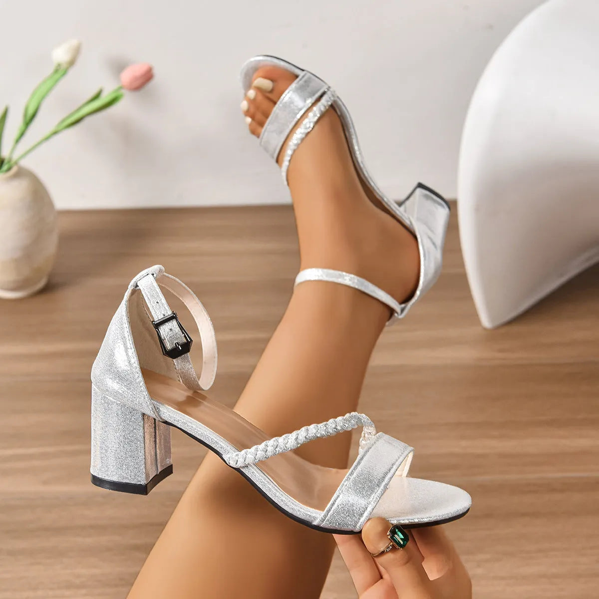 Mid heel chunky heel silver open toe buckle sandals with round toe and PU upper on display