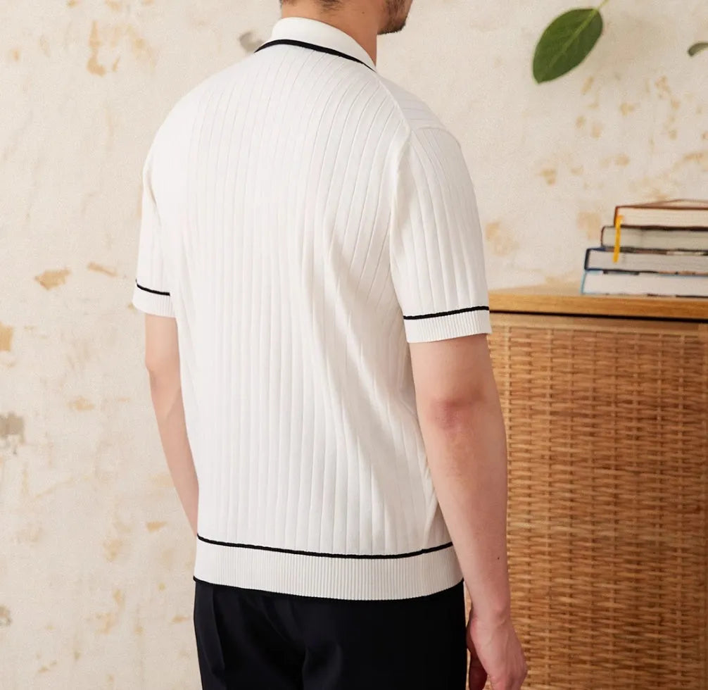 Slim black elastic knit polo shirt with a lapel collar and short sleeves on a hanger.