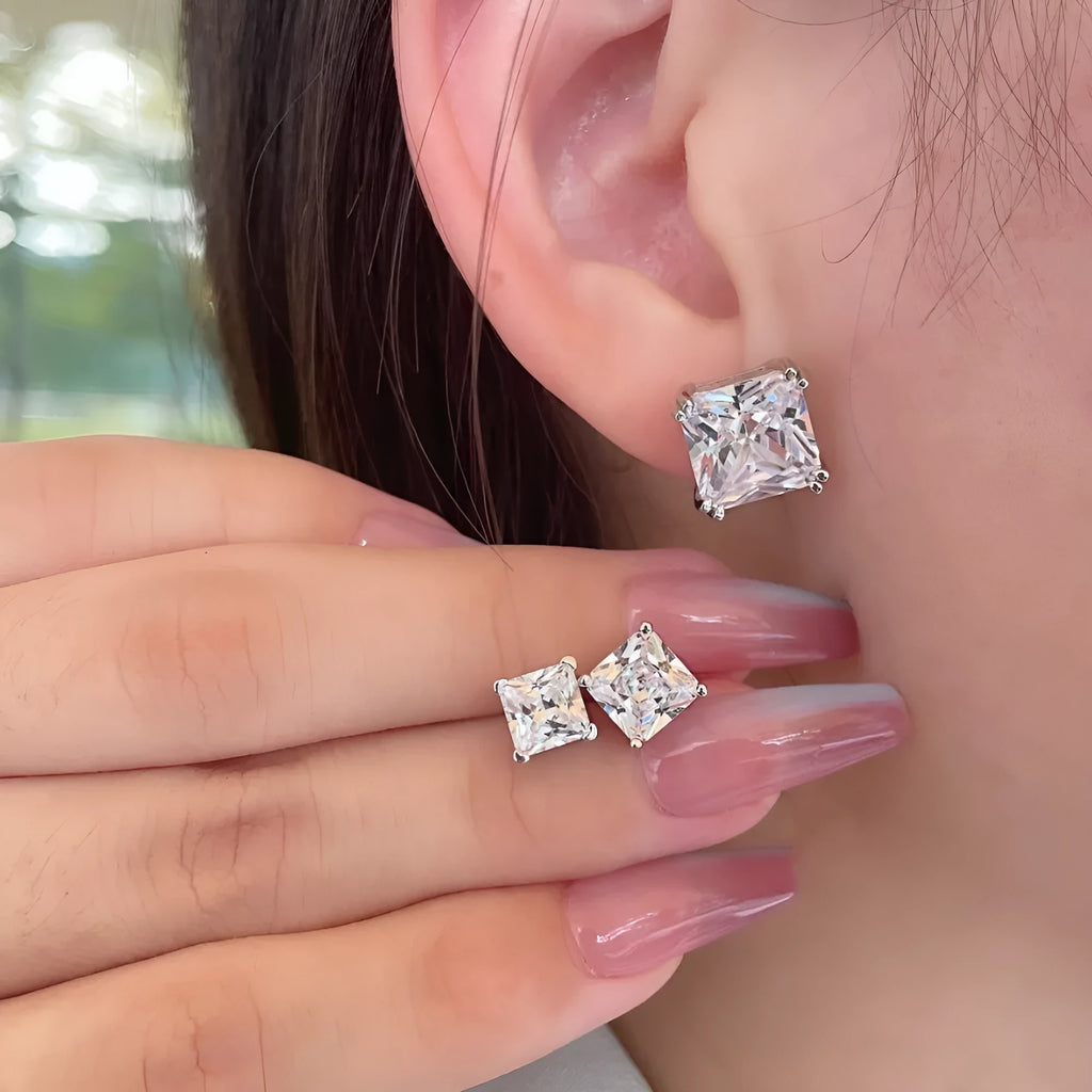 Pair of sterling silver geometric stud earrings with heart and square shapes